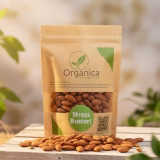 Organica The Organic Store kraft paper pouch containing premium baked almonds labeled 'Stress Buster', displayed on natural stacked wooden platforms with a soft, sunlit organic background."
