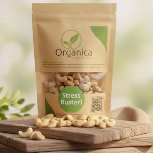 A stand-up kraft paper pouch of Organica The Organic Store Premium Cashew Nuts labeled "Stress Buster," placed on a rustic wooden platform. Loose, golden-brown cashew nuts are scattered on the wood in the foreground. The background features soft, natural daylight with blurred green foliage, highlighting the organic and fresh quality of the dry fruits.